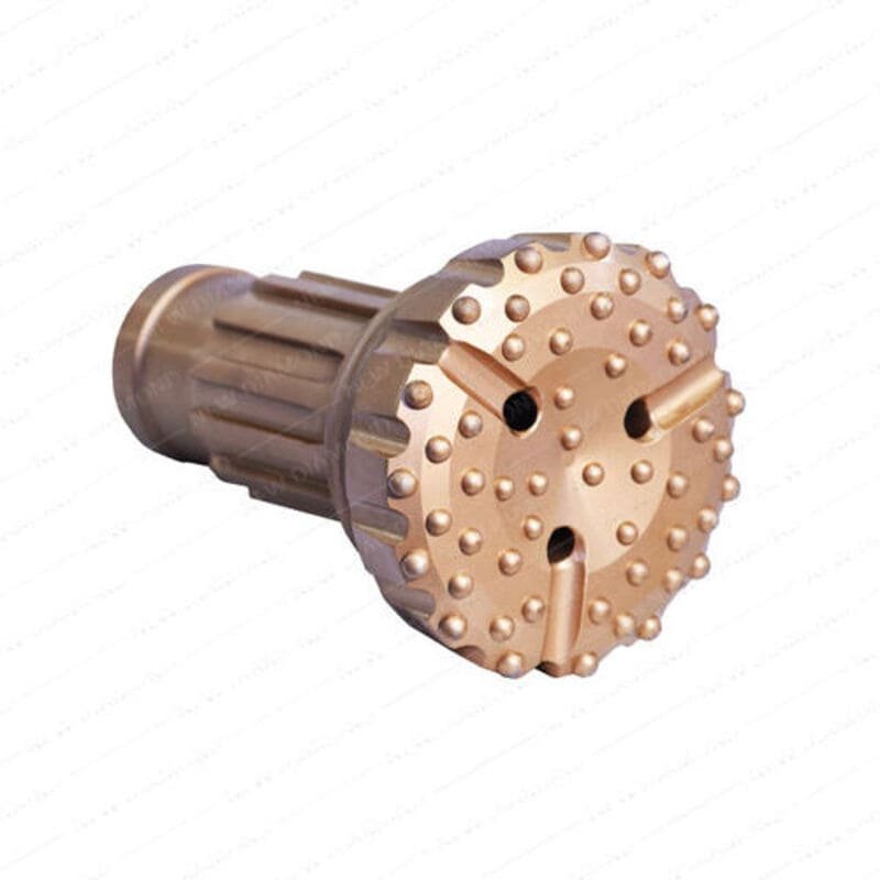 Concave face drill bit against a rugged rock background