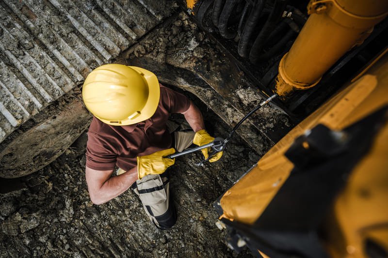 Construction site with DTH drilling equipment and workers