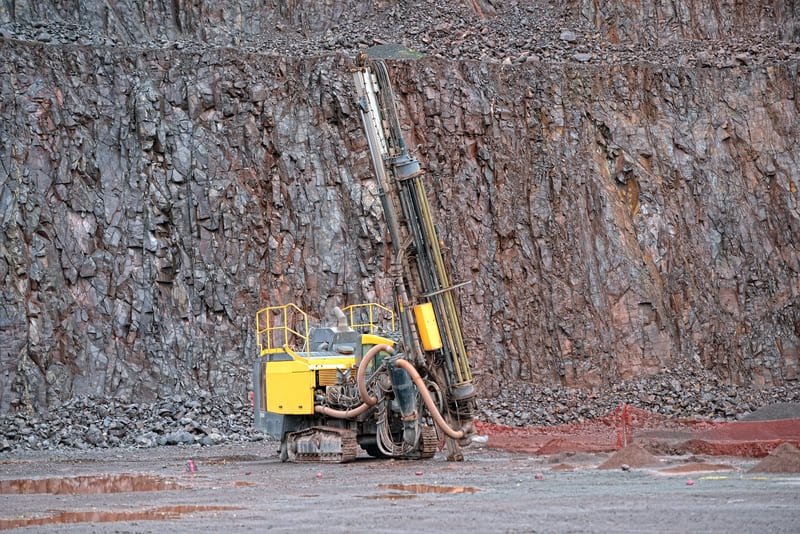 A DTH drill bit in action at a construction site