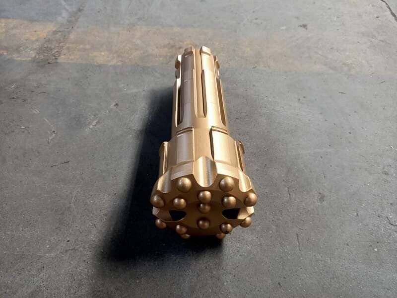 Close-up of a DTH drill bit with tungsten carbide elements