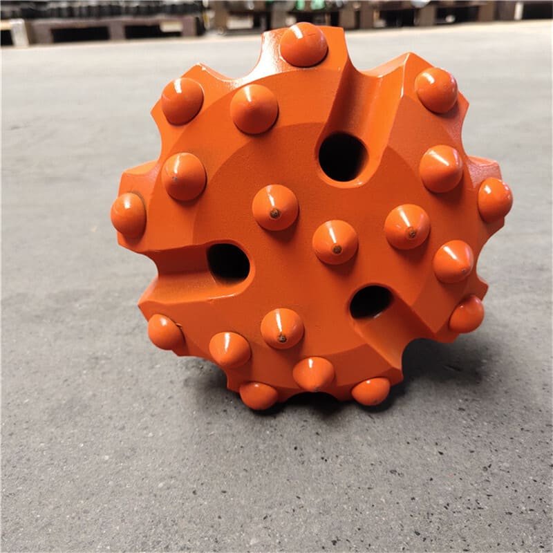 Photorealistic tungsten carbide drill bit against rock surface