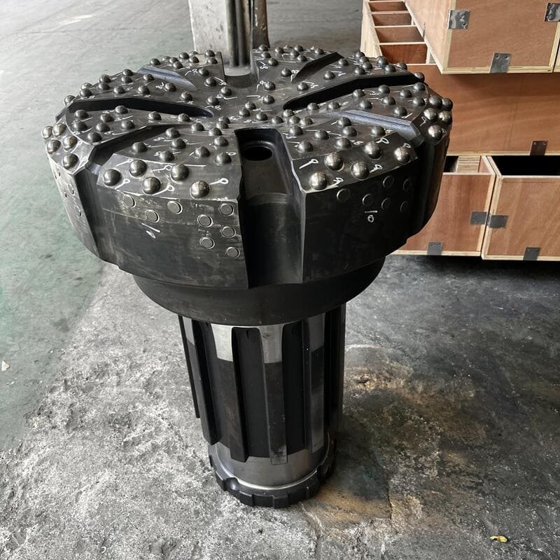 Close-up of a DTH drill bit in action at a construction site