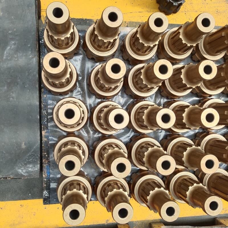Assortment of DTH drill bits on a wooden surface