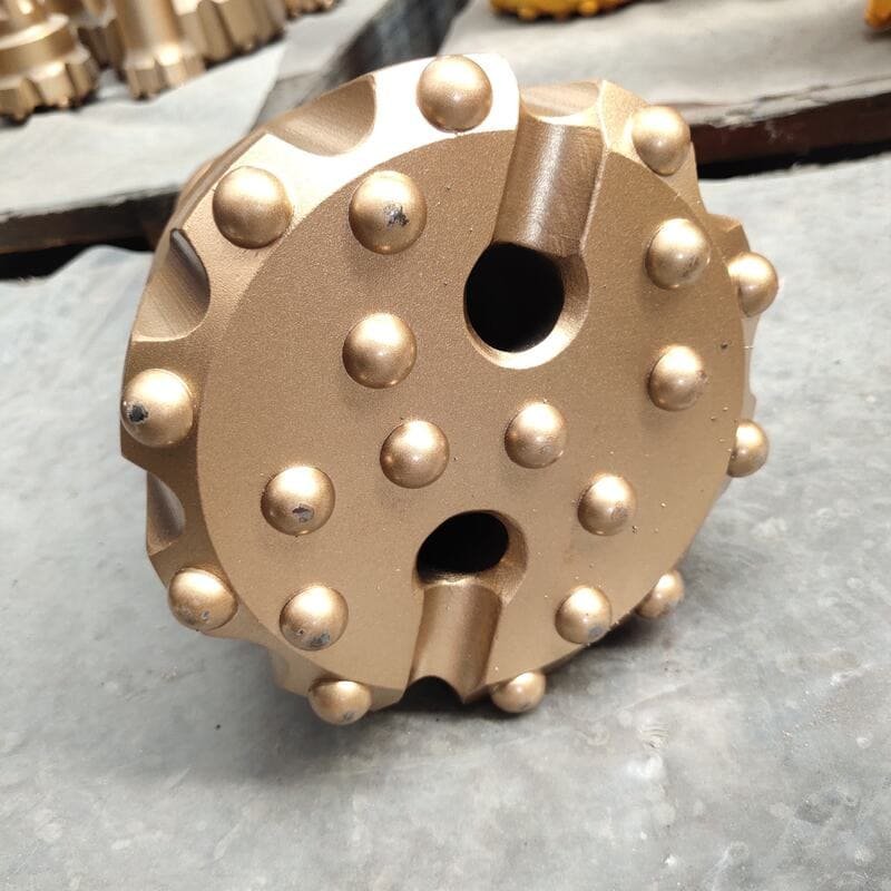 Close-up of a Down-The-Hole drill bit showcasing steel body and carbide buttons