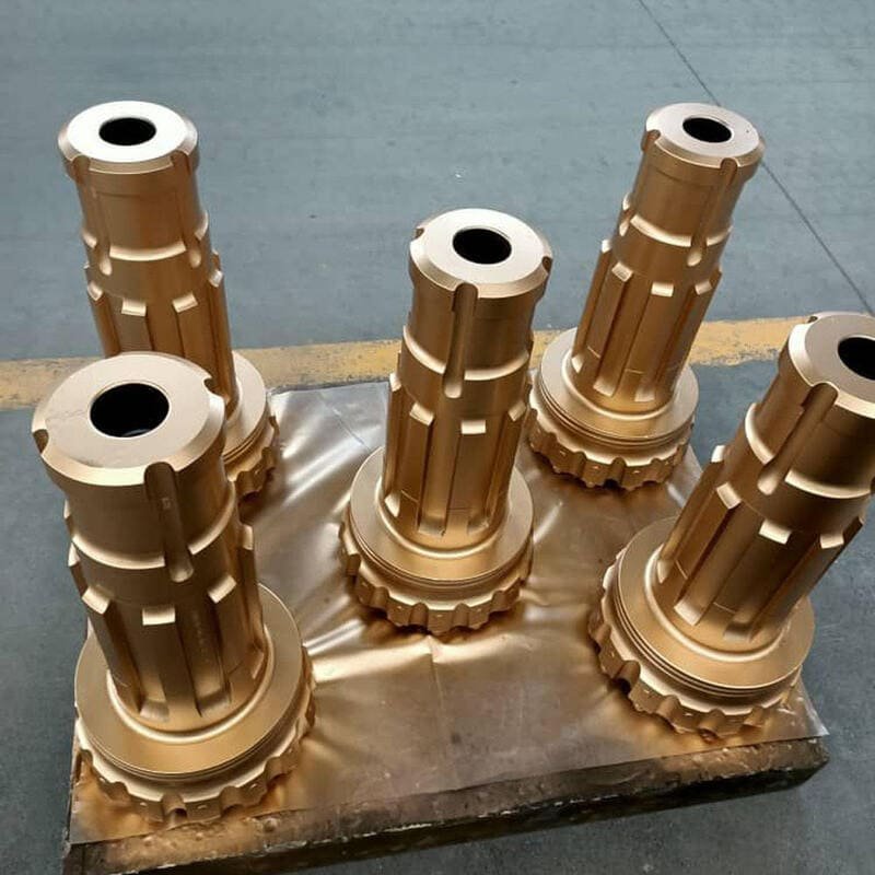 Close-up of a damaged drilling bit against rock formations