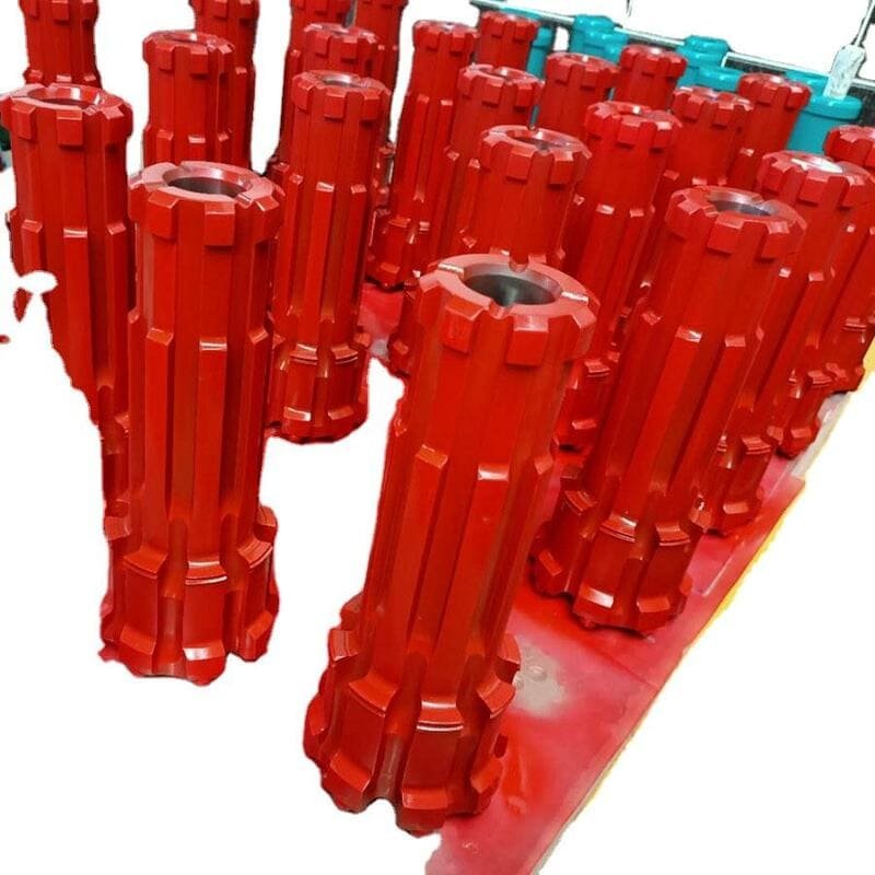 Close-up view of various steel drill bits on a wooden workbench
