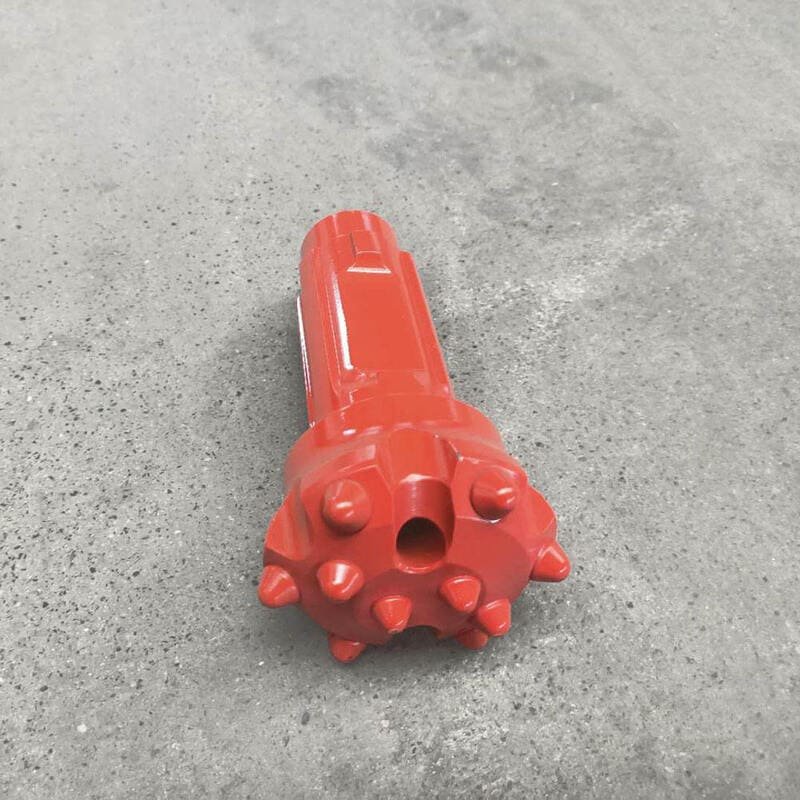 DTH drill bit in action on a construction site