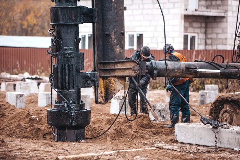 Water well drilling rig in operation at a construction site