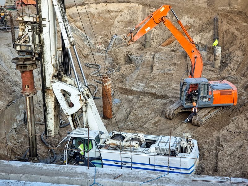 Industrial drilling rig in operation with technicians monitoring