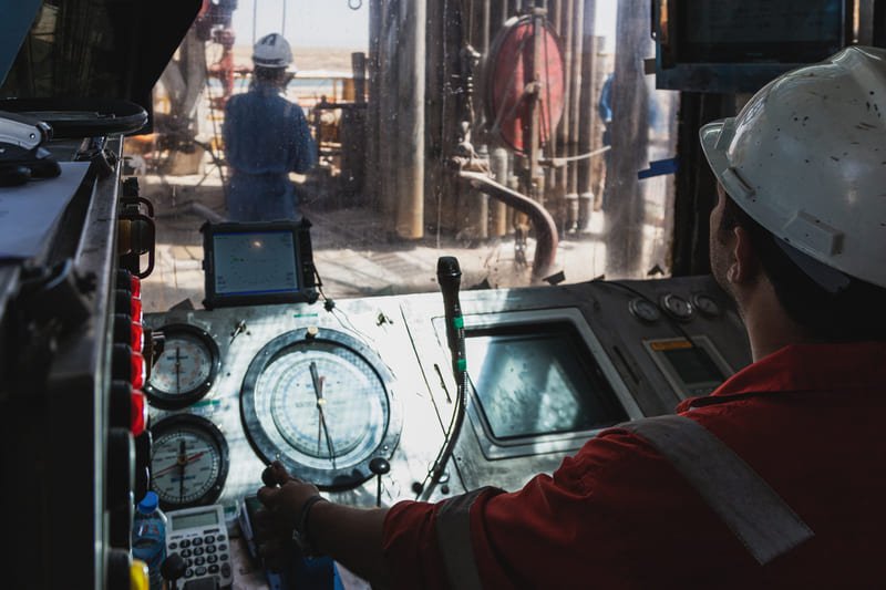 DTH drill bit drilling into hard rock at an oil exploration site