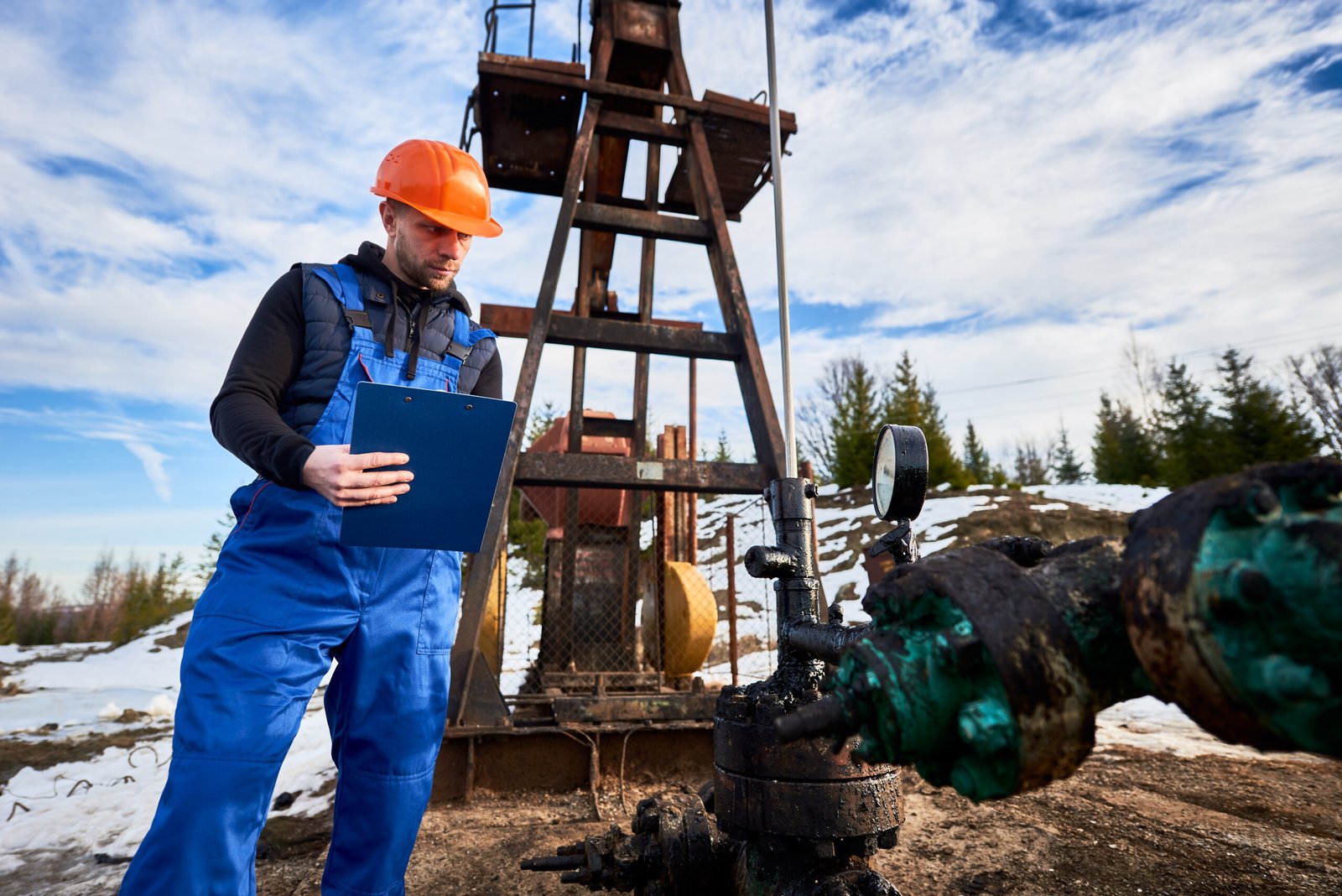 Technician inspecting machinery in an industrial setting