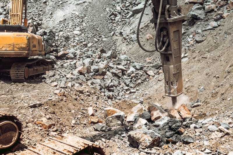 Photorealistic image of a drill bit in action on a rock surface