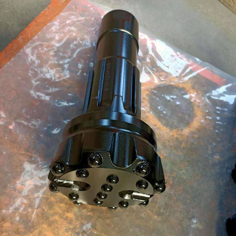 Close-up of black DTH drill bits showcasing their intricate design and robust construction for efficient drilling.