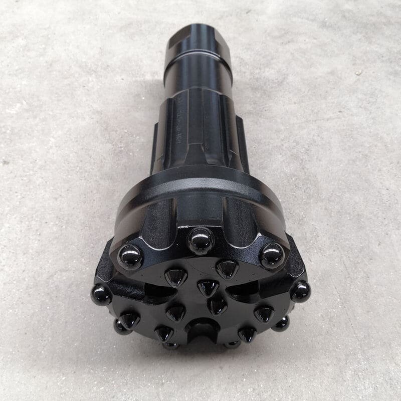 Close-up of black DTH bits, showcasing their intricate design and durable material for drilling applications.