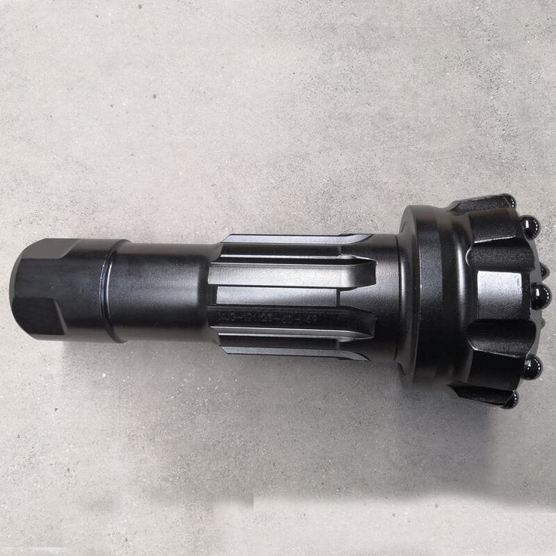 Close-up view of black DTH bits, showcasing their intricate design and robust construction for drilling applications.