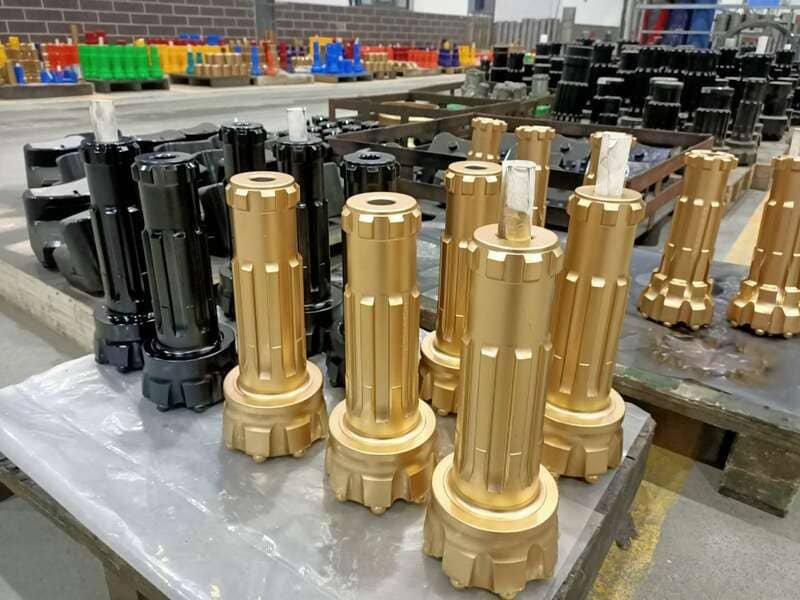Close-up view of DTH drill bits showcasing their intricate design and sharp cutting edges for efficient drilling.