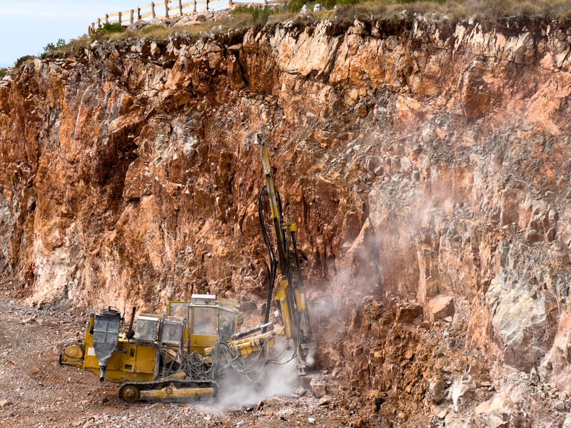 Construction site with drilling rig and various drilling bits
