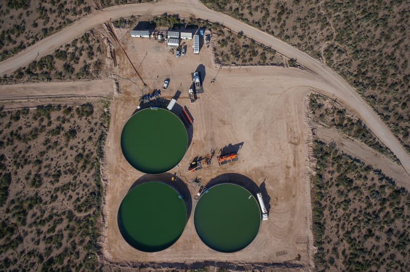 A serene image of deepening wells, showcasing their intricate structure and the surrounding natural landscape.