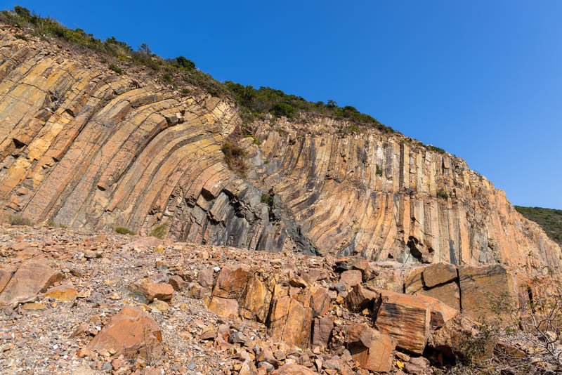 A rugged landscape showcasing various geological formations, highlighting the challenges faced in understanding Earth's processes.