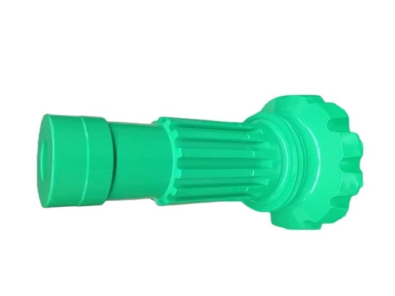 A green DTH drill bit designed for efficient drilling in various geological conditions.