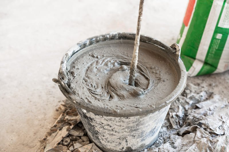 A close-up view of grouting processes, showcasing the application of grout in construction and repair work.