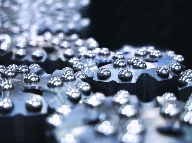 Close-up of Mincon DTH drill bits on a wooden workbench