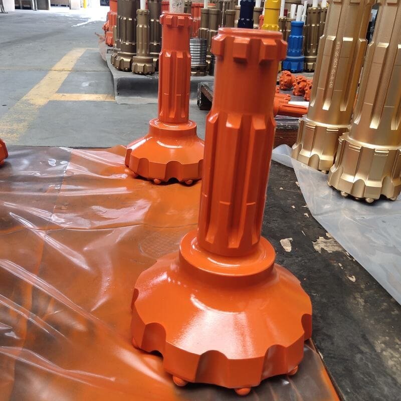 Close-up of a worn DTH drill bit with crater wear patterns
