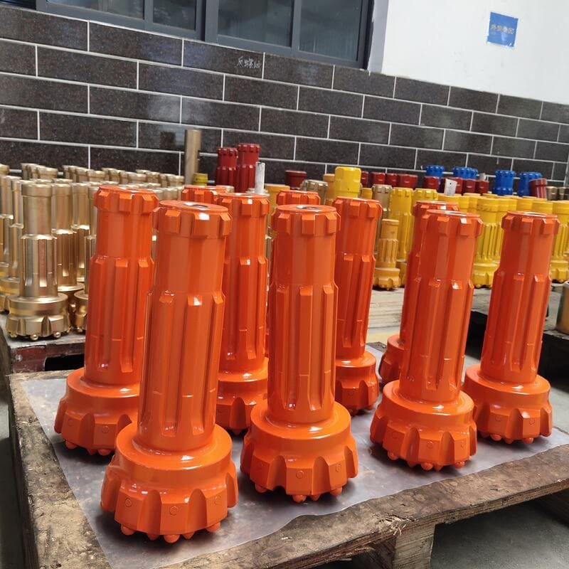 Close-up view of DTH drill bits showcasing their intricate design and sharp cutting edges for efficient drilling.