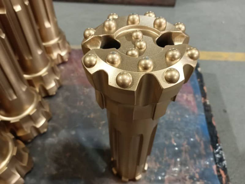 Close-up view of Tungsten Carbide DTH bits, showcasing their intricate design and durable material for drilling applications.