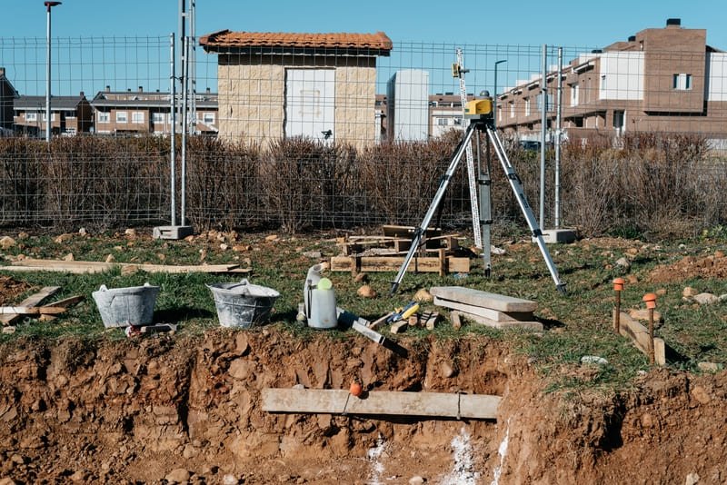 A construction site showcasing the process of building a reinjection well, with machinery and workers in action.