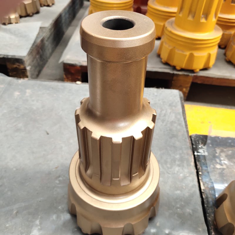 Close-up view of a DTH drill bit, showcasing its intricate design and sharp cutting edges for efficient drilling.